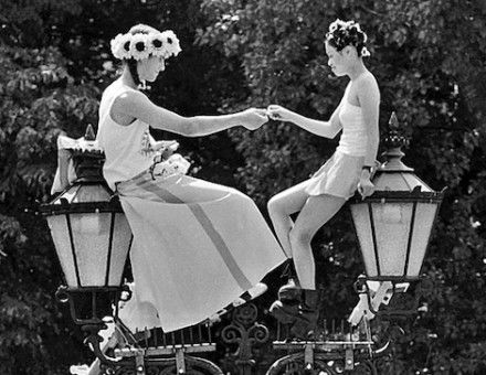 Revellers sit atop a street lamp during the Love Parade, by Gerd Danigel, 1997. Deutsche Fotothek. Public Domain.
